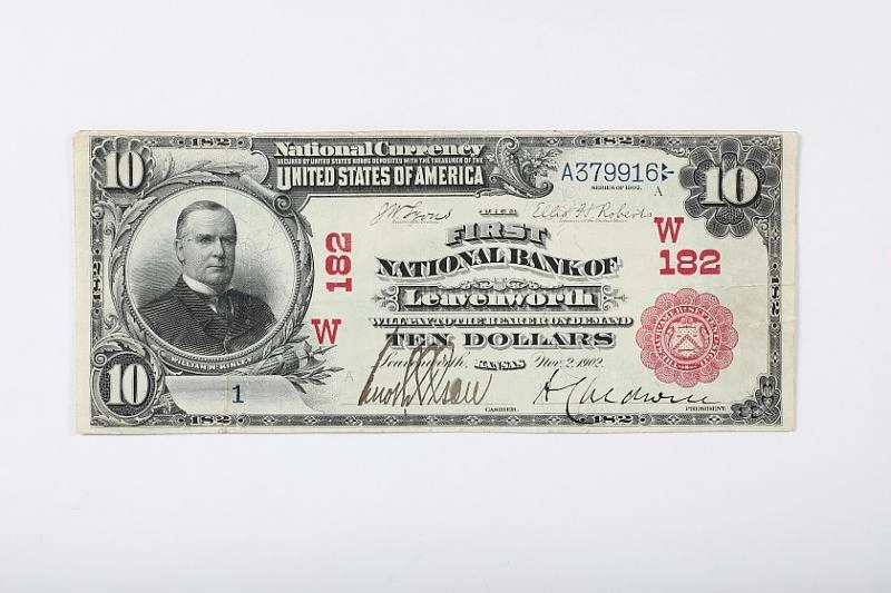 A 1902 ten-dollar National Bank Note issued by the First National Bank of Mitchell, South Dakota; the issuing bank and town are printed on the face.